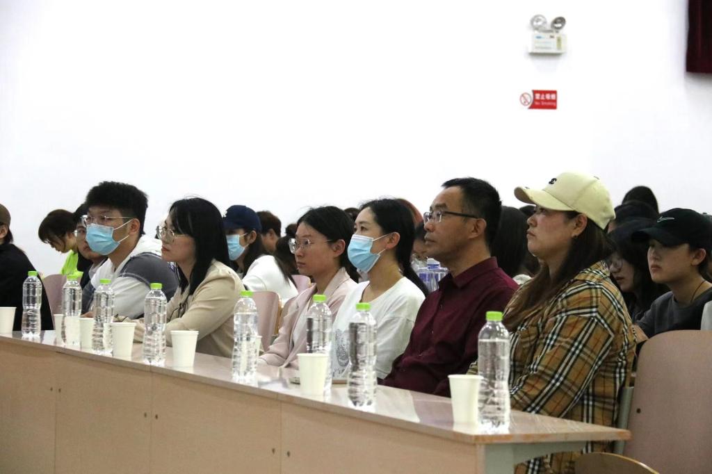 一群人坐在桌子前描述已自动生成 一群人坐在桌子前描述已自动生成